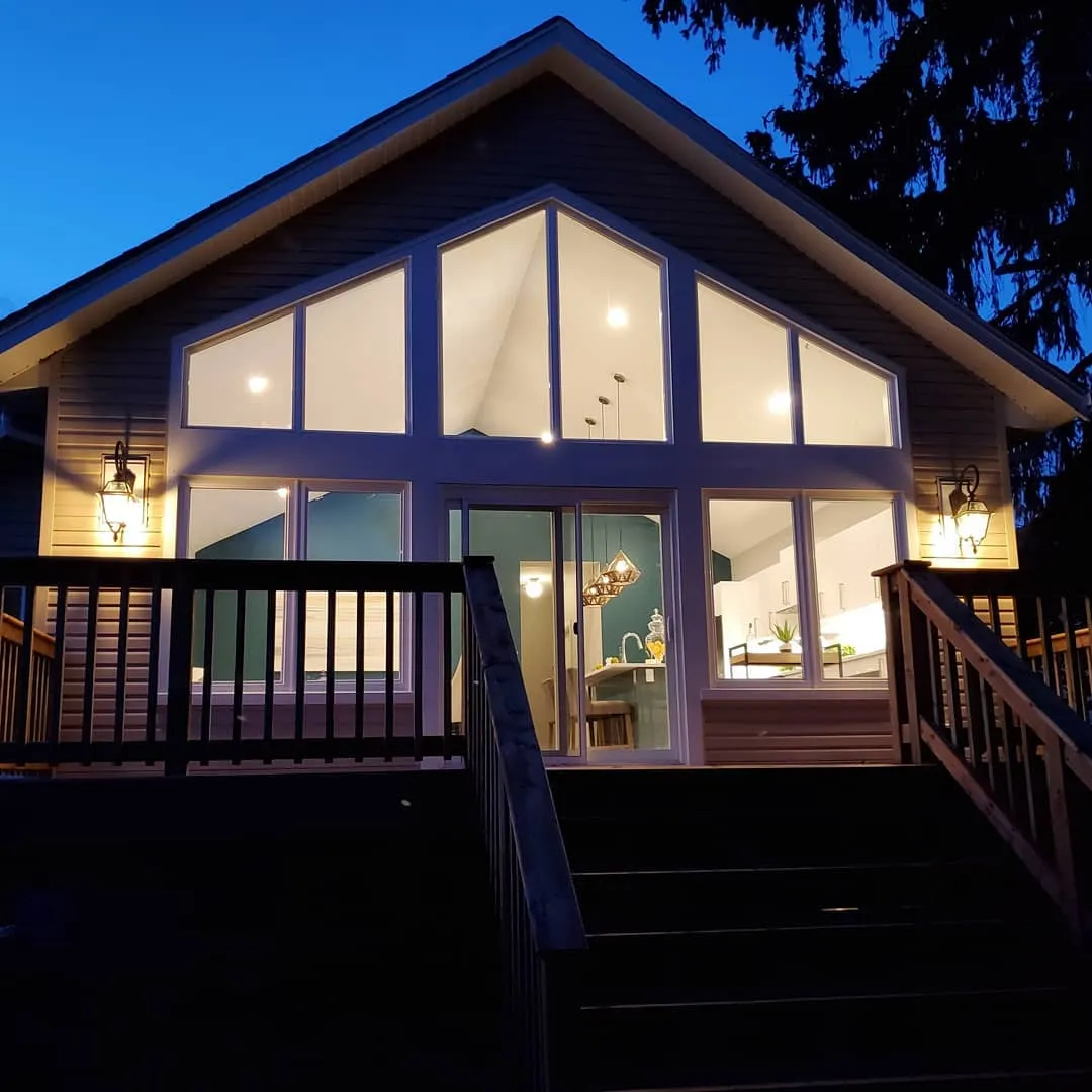Kitchen addition with full height windows at dusk in Galt by Caliber Contracting