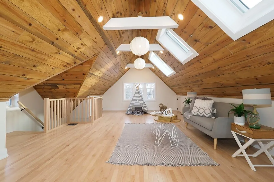 Attic finishing with wood ceiling and skylights in Kitchener by Caliber Contracting